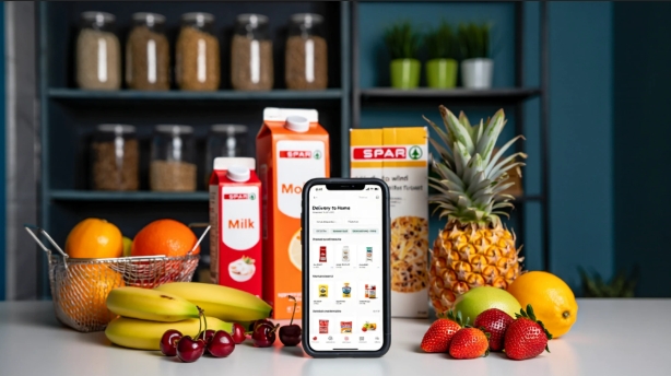 The SPAR UAE delivery app shown on a phone, surrounded by fresh groceries.